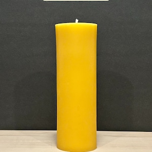 May include: A large, yellow, cylindrical candle with a white wick. The candle is 9 inches tall and has a burn time of 150 hours.