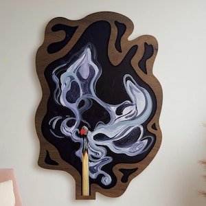 May include: Abstract wall art showing a burning match with smoke. The artwork has a dark brown wooden frame, a black background, and white and purple smoke. The match head is red, and the matchstick is yellow.
