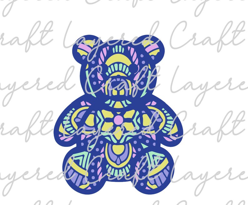 May include: A blue teddy bear with a colorful mandala pattern. The pattern includes shades of yellow, green, pink, and purple.