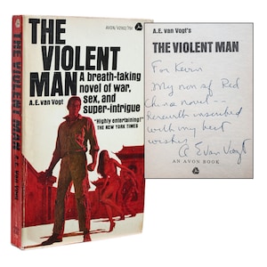 May include: A red and white paperback book titled "The Violent Man" by A.E. van Vogt. The book cover features a man in a white shirt and blue jeans standing in front of a red building. A woman in a red dress is walking behind him. The book is signed by the author, A.E. van Vogt, with a dedication to Kevin.