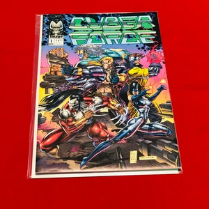 May include: A comic book titled "CYBER FORCE" with a group of action figures on the cover. The comic book is in a plastic sleeve. The cover features a variety of characters in action poses, with vibrant colors and dynamic artwork.