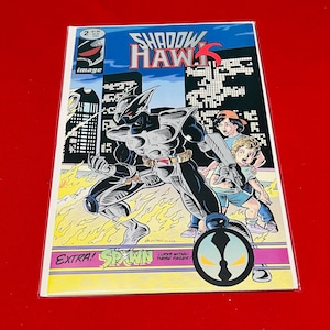 May include: Comic book cover featuring a black and silver superhero character called Shadow Hawk. The character is standing in front of a city skyline with two children. The cover also features the text "Shadow Hawk" and "Image".