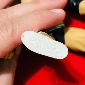 May include: White plastic foot of an action figure with the text "1997 Jakks Pacific, Inc. 1997 Titan Sports, Inc." printed on the bottom.