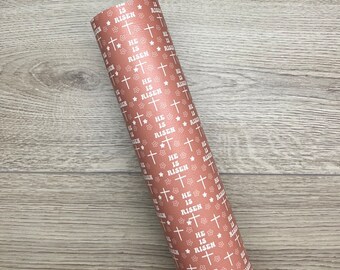 May include: A roll of brown wrapping paper with a white pattern of crosses and the words "He is Risen" repeated.