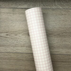 May include: A roll of pink and white gingham patterned wrapping paper.