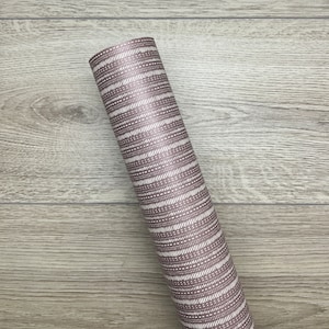 May include: A roll of brown and white patterned wrapping paper. The paper has a geometric design with white lines and dots on a brown background.