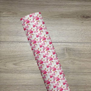 May include: A white background with a repeating pattern of pink flamingos and orange inflatable rings. The pattern is a summery design.