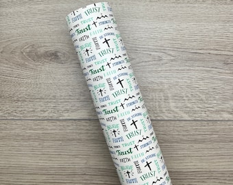 May include: White wrapping paper with a repeating pattern of the words "Faith", "Trust", "Believe", and "Be Strong" in green and blue text. A small cross is also included in the pattern.