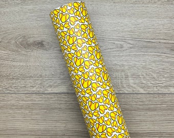 May include: A roll of white wrapping paper with a pattern of yellow softball hearts.