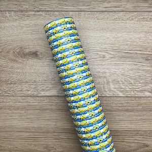 May include: A roll of yellow and blue patterned vinyl with a repeating design of school buses. The vinyl is perfect for crafting projects.