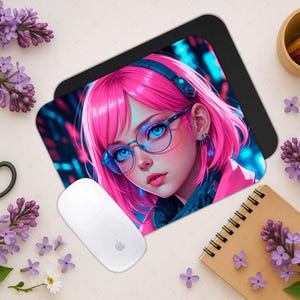 May include: A mouse mat with a colourful anime-style image of a girl with pink hair, blue eyes, and glasses. A white computer mouse is next to the mat. The scene is decorated with purple flowers, scissors, and a notepad.