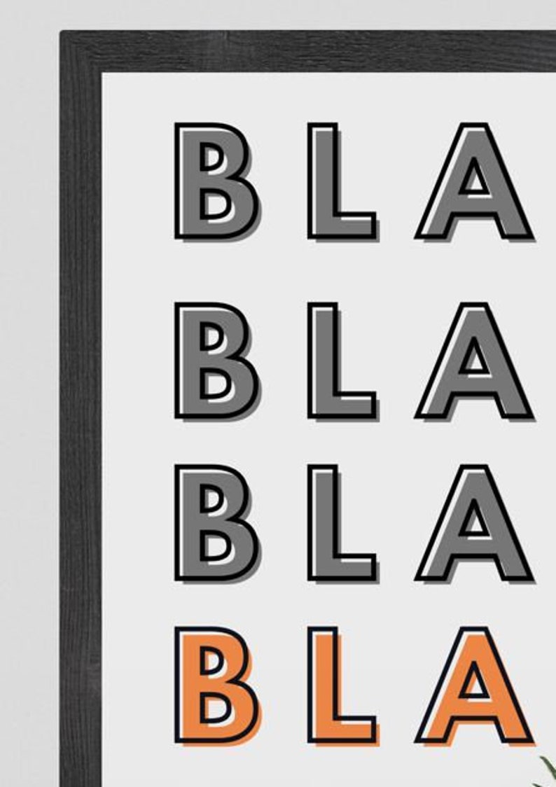 May include: A framed print with the word "BLA" repeated four times in a bold, black font. The last "BLA" is in a lighter orange color.