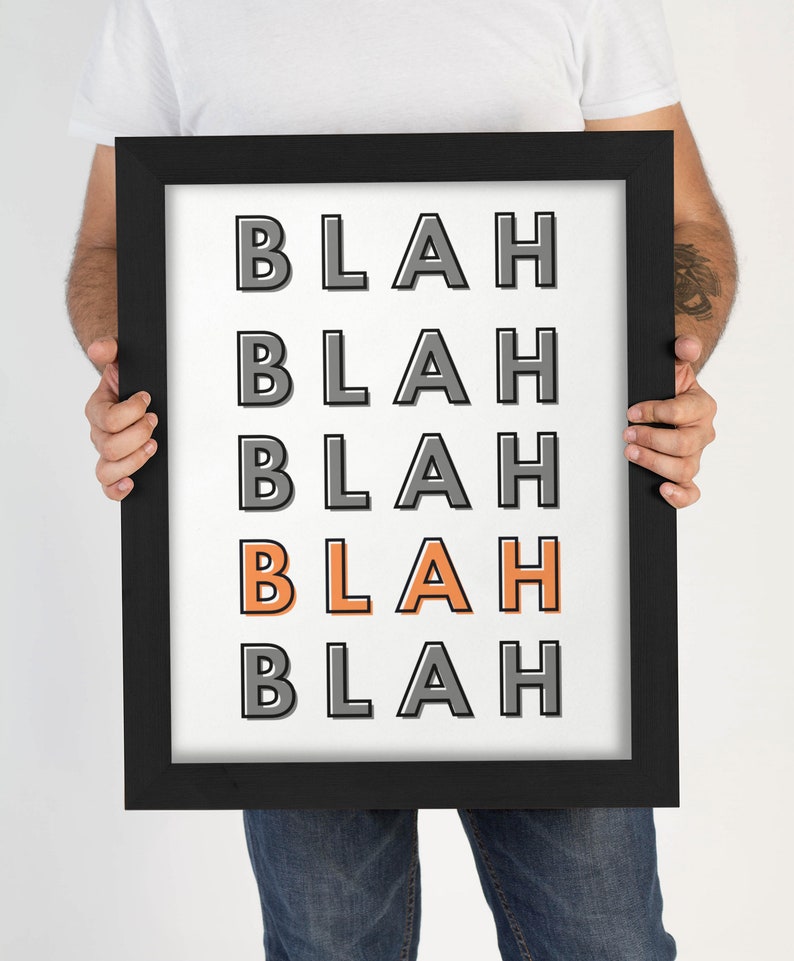 May include: A framed print with the word "BLAH" repeated five times in a black and white color scheme. The word "BLAH" in the middle is orange.