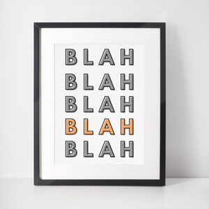 May include: A framed print with the word "BLAH" repeated five times in a vertical column. The word "BLAH" is in a gray font with a black outline, except for the third "BLAH" which is in an orange font with a gray outline.