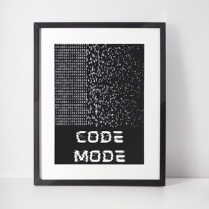 May include: A framed print with a black border. The artwork displays a black and white binary code design that fades into a scattered pattern. The words "CODE MODE" are shown in white, glitch-style text at the bottom.