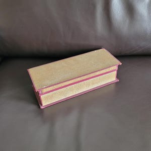 Antique cardboard glove box with lid in the colours gold and burgundy