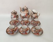 Antique porcelain Japanese Satsuma tea- or coffeeset, tea- or coffeepot, creamer, sugar bowl and 6x cup and saucer, marked