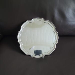 Antique silver plated English Sheffield round tray on feet with contoured edge, marked James Dixon & Sons