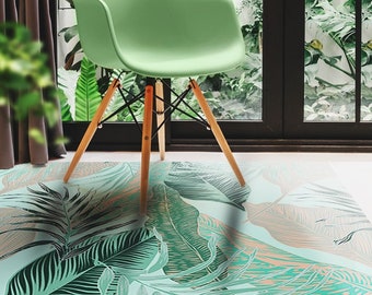 May include: A green chair with wooden legs sits on a tropical patterned rug with green and brown leaves. The rug has a light blue background.