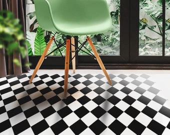 May include: A black and white checkered floor mat with a green chair sitting on top of it.