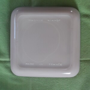 May include: White square ceramic dish with rounded edges. The bottom of the dish has the text "Made in France" and "Pyrex" logo.