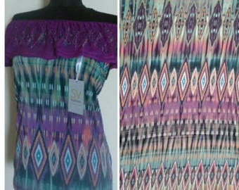 May include: Off-the-shoulder top with a purple lace trim and a colourful geometric print. The print features a pattern of diamonds and stripes in shades of blue, green, purple, and orange. The top has a tag that says "SV Fashion".