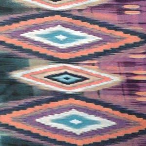 May include: A fabric with a repeating pattern of diamond shapes in shades of teal, purple, pink, and white. The diamonds are outlined in black and have a subtle ikat-like texture.