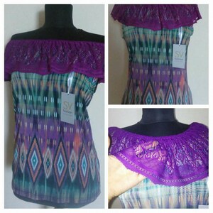 May include: Purple off-the-shoulder top with a lace trim and a colorful geometric print. The top has a tag that says "SV Fashion".