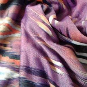 May include: Purple, orange, white, and black patterned fabric with a soft, flowing texture.
