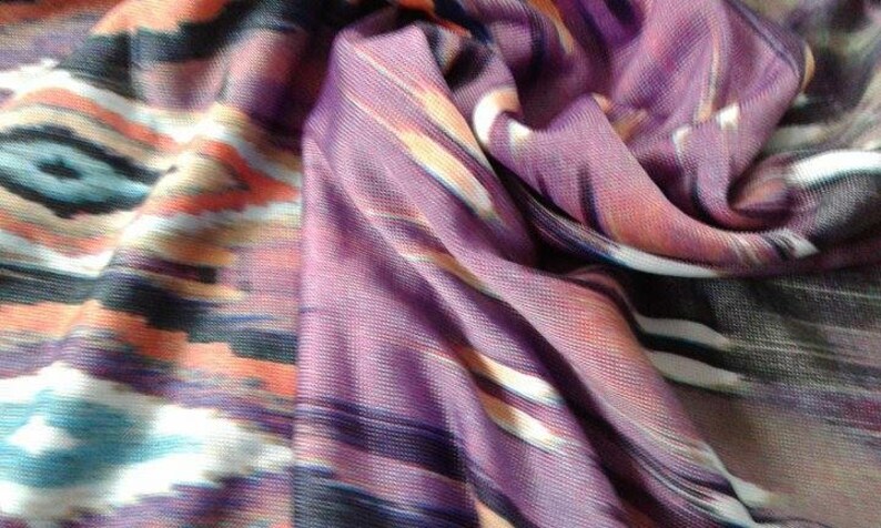May include: Purple, orange, white, and black patterned fabric with a soft, flowing texture.