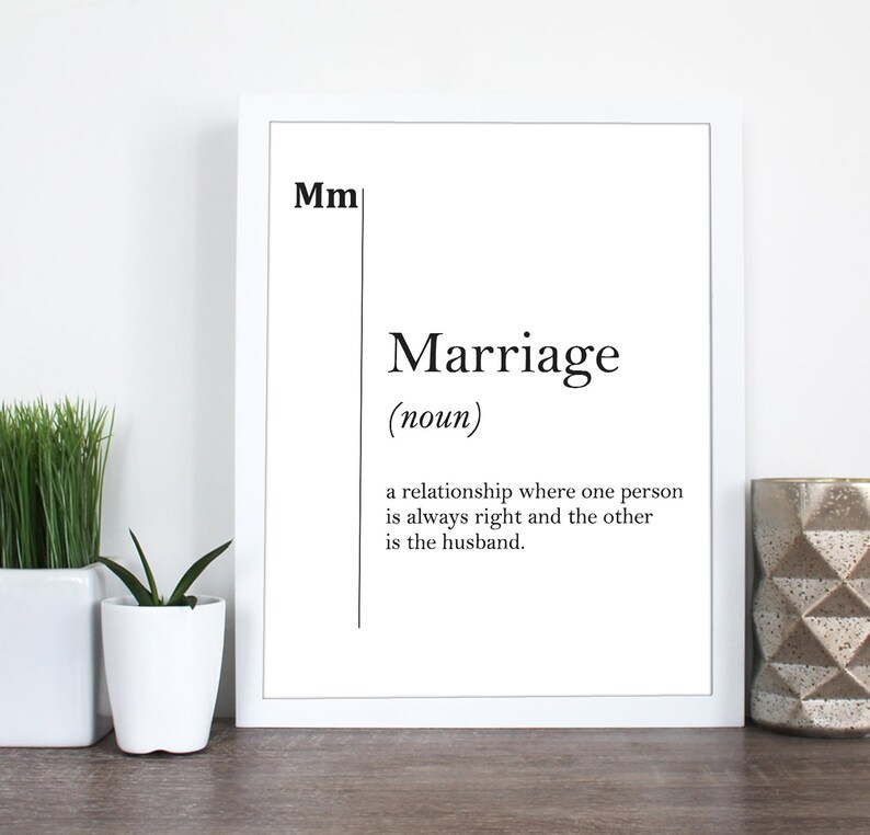 May include: A white framed print with black text that reads "Mm Marriage (noun) a relationship where one person is always right and the other is the husband."