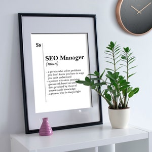 May include: A black and white printable poster with a humorous definition of an SEO Manager. The definition reads: "A person who solves problems you don't know you have in ways you can't understand. A person who does precision guesswork based on unreliable knowledge. A person who is always right."