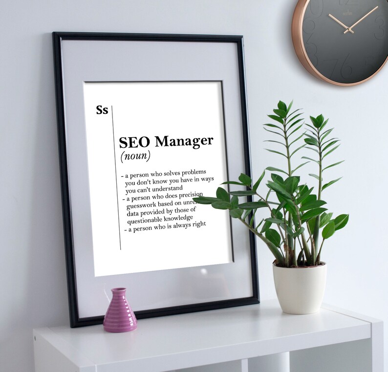 May include: A black and white printable poster with a humorous definition of an SEO Manager. The definition reads: "A person who solves problems you don't know you have in ways you can't understand. A person who does precision guesswork based on unreliable knowledge. A person who is always right."