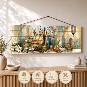 May include: A rectangular wooden wall sign featuring a printed illustration of glass perfume bottles, a metal oil lamp, and white flowers. The artwork includes a hanging lantern and architectural arches. A brown rope is attached for hanging the sign.