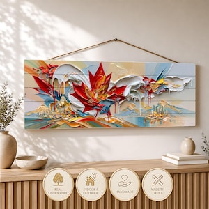 May include: A rectangular wall hanging made of horizontal linden wood planks featuring a thick, textured impasto oil painting of a large red maple leaf with white, blue, and yellow accents. The artwork is suspended by a brown rope cord.