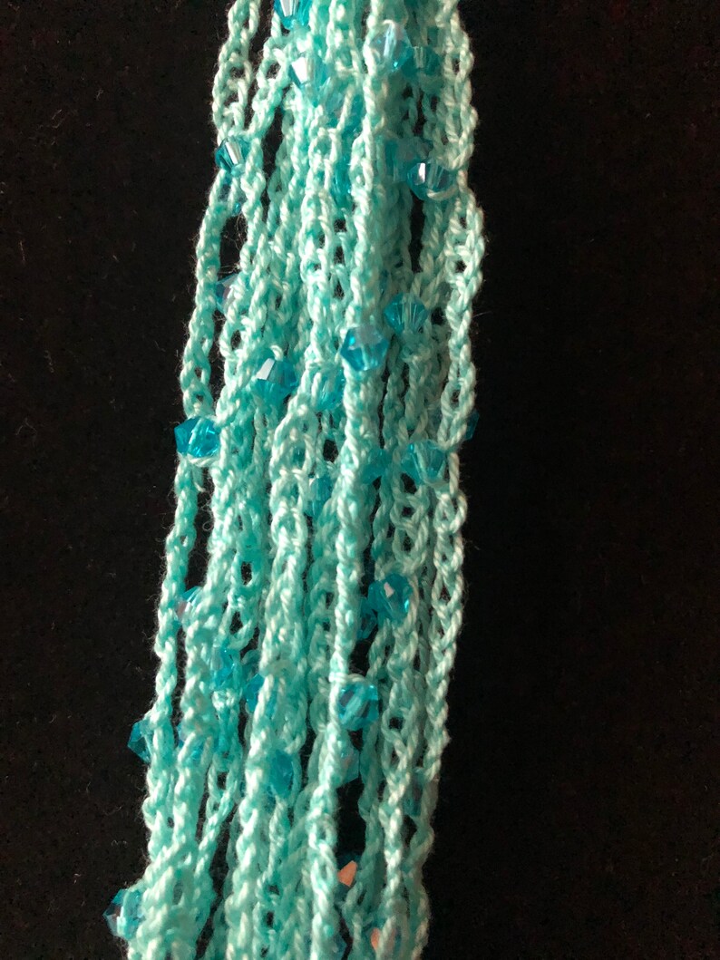 100/% cotton thread with Chengmu 4mm Bicone glass beads. Crocheted beaded multi strand necklace