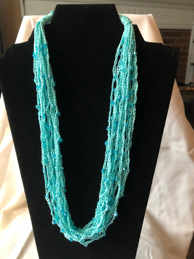 100/% cotton thread with Chengmu 4mm Bicone glass beads. Crocheted beaded multi strand necklace