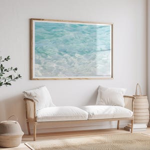 Turquoise water art print by Cattie Coyle Photography above couch. All rights reserved.