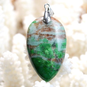 May include: A green and brown gemstone pendant with a silver bail. The gemstone has a unique swirling pattern.