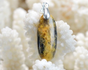 May include: A yellow and black oval pendant with a silver bail. The pendant is made of a natural stone with a unique pattern.