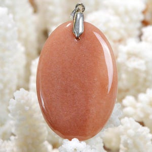 May include: A handmade, wooden cutting board with a natural finish. The board features a live edge on one side and a smooth, rectangular shape. It is approximately 18 inches long and 12 inches wide.