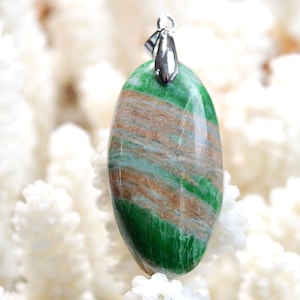May include: A green and brown oval pendant with a silver bail. The pendant is made of a natural stone with a striped pattern.