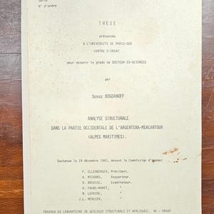 May include: A black and white thesis paper with the title "Analyse Structurale" and the text "Soutenue le 19 decembre 1980, devant la Commission d'examen" printed on it.