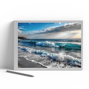 May include: A framed print featuring a coastal scene with turquoise waves crashing on a sandy beach under a partly cloudy sky. The artwork is displayed on a white surface with a gray stylus.
