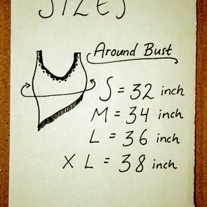 May include: A handwritten chart showing sizes for a garment, with a simple drawing of a tank top. The chart lists sizes S, M, L, and XL with corresponding bust measurements in inches: 32, 34, 36, and 38 inches.