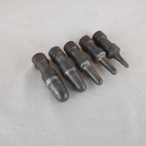 May include: Six metal punch tools with different sized tips. The tools are silver and gray with a worn finish.