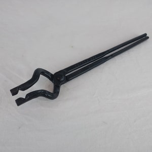 May include: Black metal blacksmith tongs with a long handle and a curved jaw.