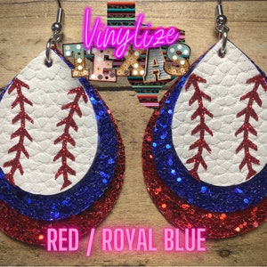 May include: Red and royal blue layered leather earrings with a white baseball design. The earrings are shaped like teardrops.