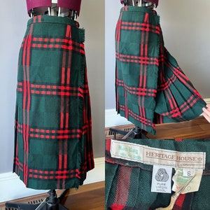May include: A green and red tartan kilt skirt with a fringed hem. The skirt is labelled "Rob Roy by Highland Queen" and "Heritage House". The label also states "Pure Virgin Wool".