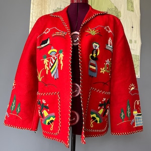 May include: A vibrant red jacket with colorful embroidered designs. The jacket features detailed stitching around the edges and pockets, and is adorned with various embroidered figures and landscapes. The jacket is displayed on a mannequin.